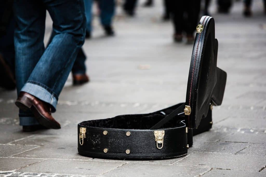 Buskers black guitar case open for donations, for people on the streets.