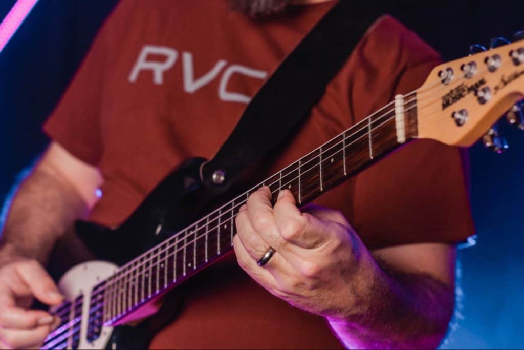 Red shirt guitar player.