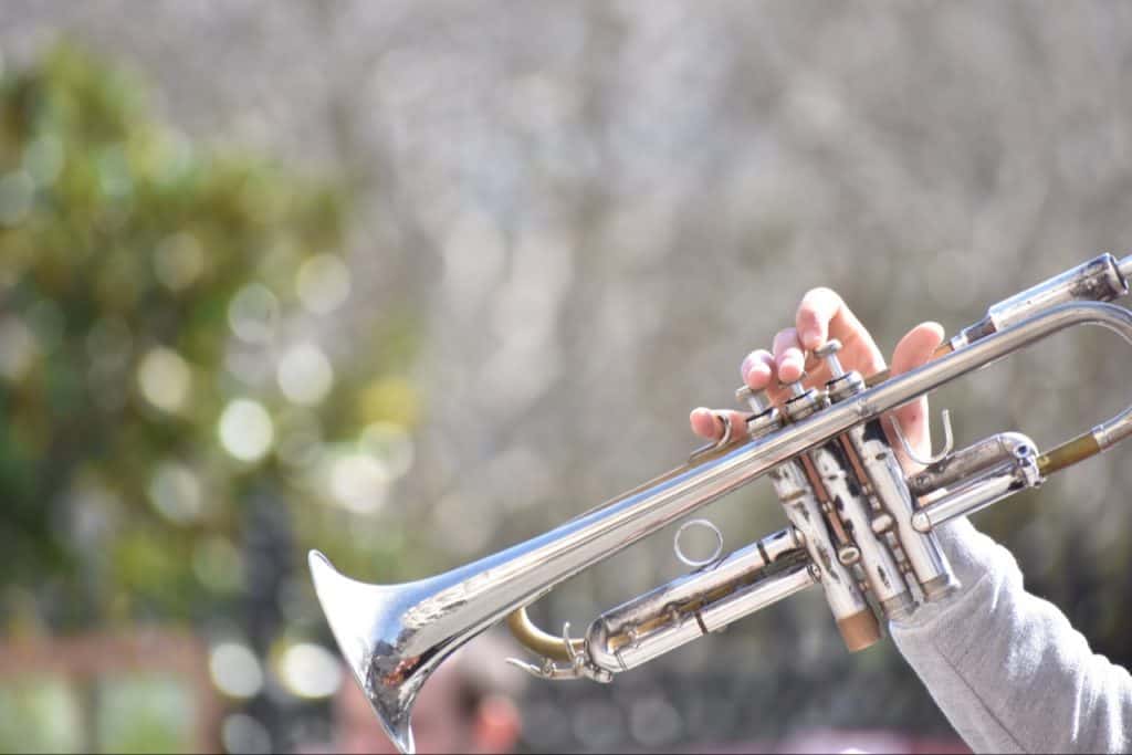 Trumpet player, playing trumpet.