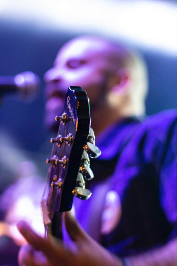 Guitar player, playing in blue background.