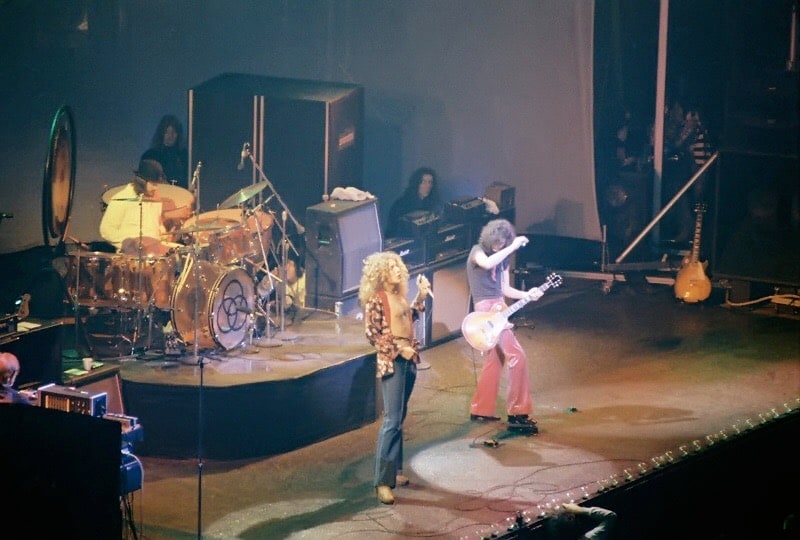 Led Zeppelin on stage performing and playing instruments. Color photo. Photo courtesy of more19562003. Commons.m.wikimedia.org