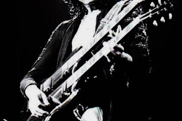 Jimmy Page playing guitar. Black and white picture.