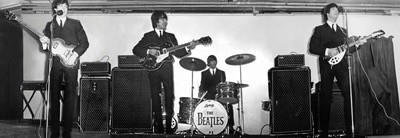 The BEATLES band, all playing their instruments.Black and white picture.