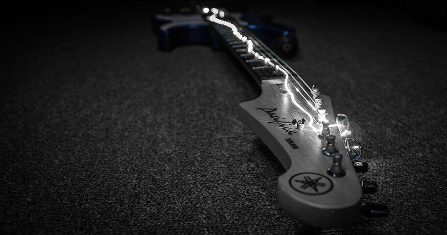 Yamaha Pacifica Guitar, with a bright string light, going on top of the guitar.