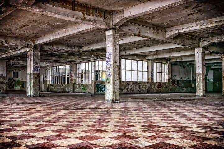 Huge,empty, vacant, graffiti filled building.