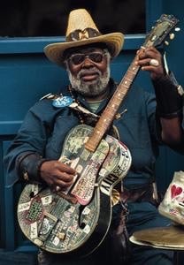 Blues guitar player, playing guitar outside, having fun, playing tasty blue chords.