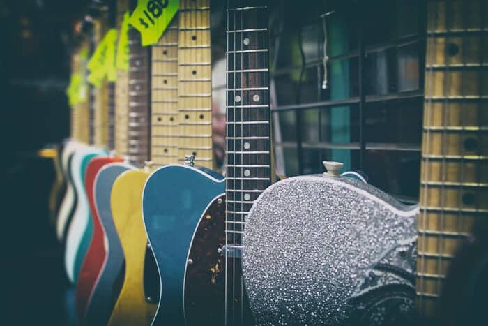 Different sorts of different color guitars, for sale in music store.