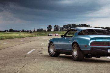 Real fast blue Camero race car on track, with other cars in front of it.