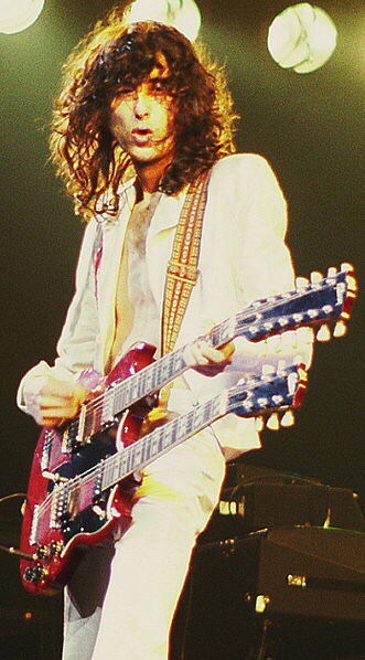 Jimmy Page of Led Zeppelin. Playing double guitar. Color Image.