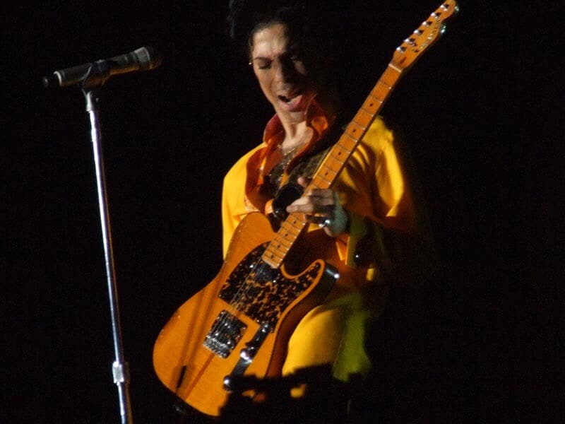 Prince playing guitar. Rocking and funking out. Photo courtesy of Scott Penner. From commons.m.wikimedia.org