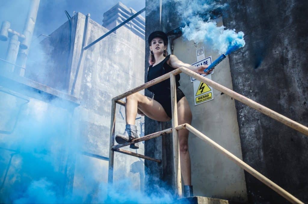 Girl with blue smoke bomb.