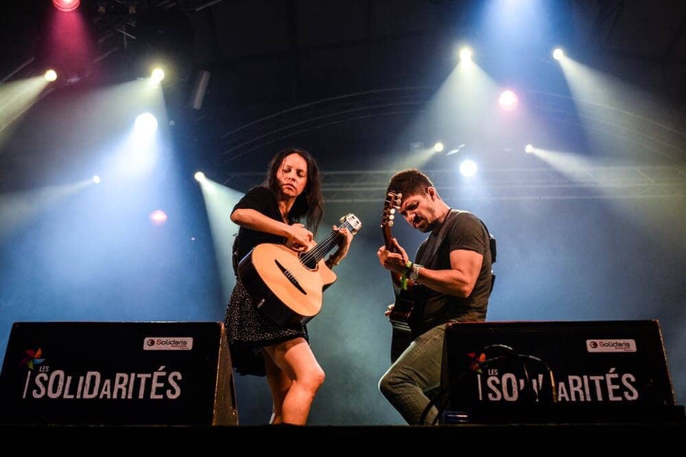 Man and woman playing guitar on stage, having fun!