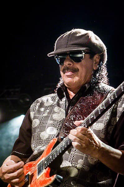 Carlos Santana playing orange guitar. Jamming on guitar! Photo credit to Larry Philpot www.soundstagephotography.com ,check it out, it’s a GREAT website. (Photo from commons.m.wikimedia.org)