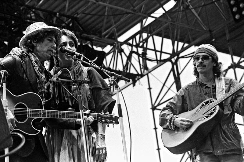 Carlos Santana early days, on stage with Dylan and Baez. Santana with cool looking guitar.