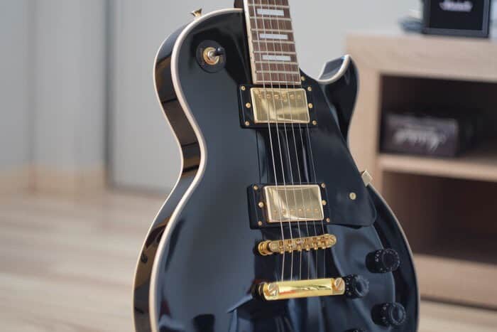 Real nice, shiny, new looking, black guitar.