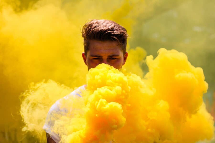 Man surrounded by yellow smoke.