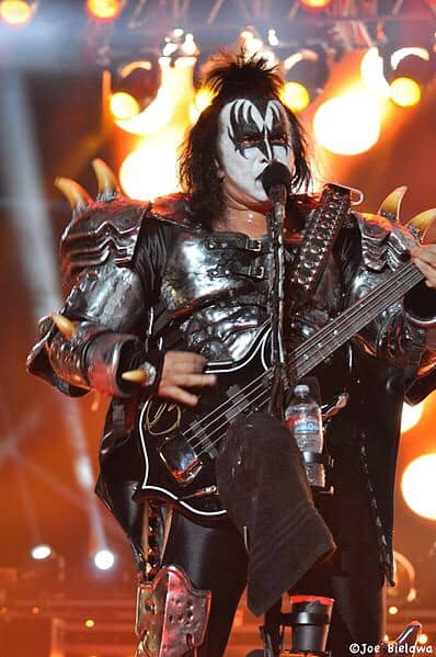 Gene Simmons of the famous rock band KISS, with fire behind him.