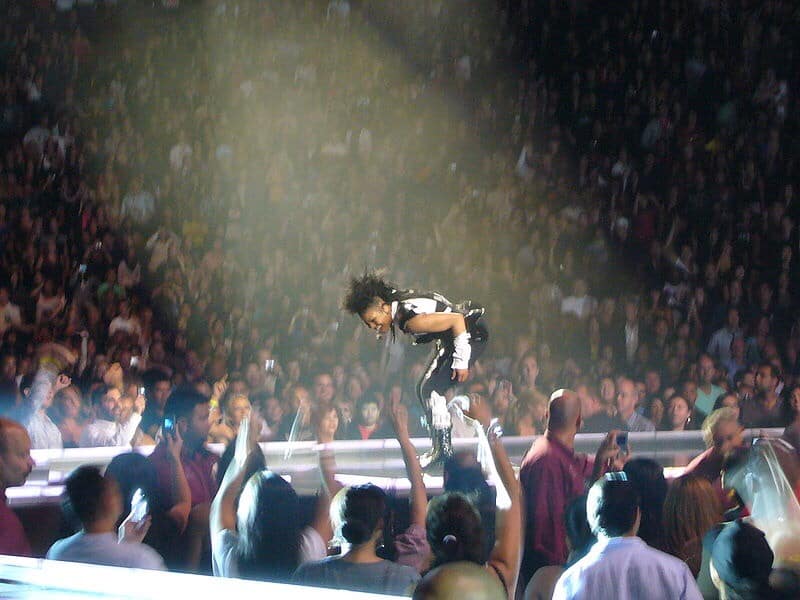 Janet Jackson performing and having fun looking down at fans, photo courtesy of Andy Liang commons.m.wikimedia.org