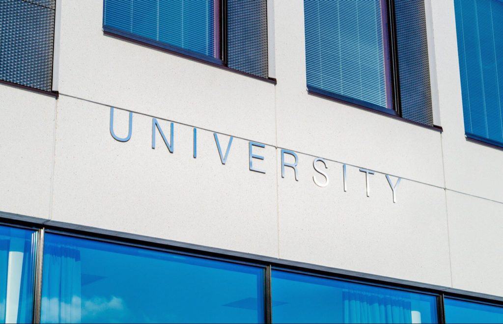 University building with letters UNIVERSITY, on it.