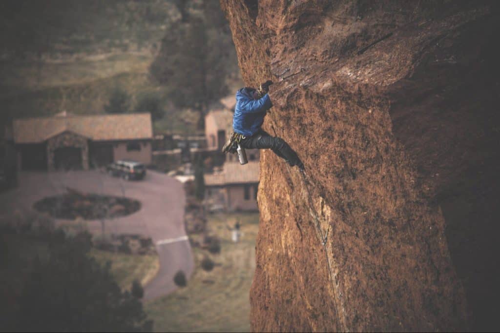 Man climbing mountain at 100 degree angle