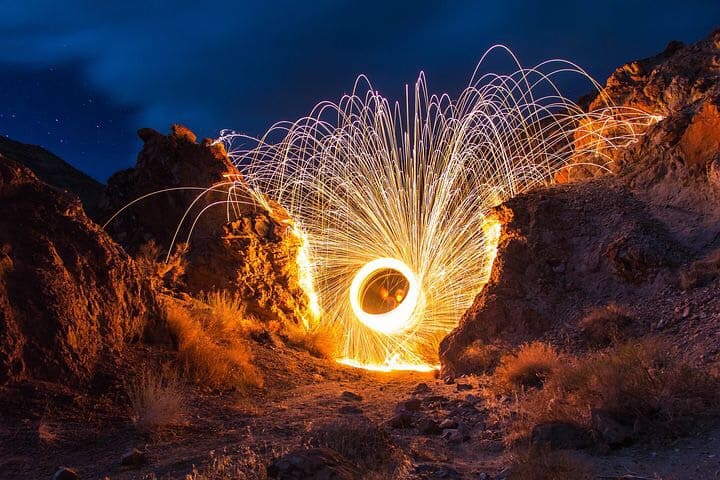 Glorious round, bright light, spinning around mountain at night.