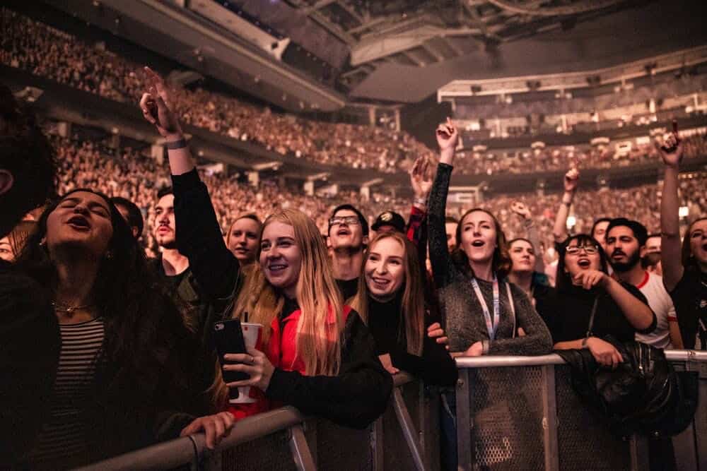 Point of view type of picture: People listening to and being excited listening to concert, huge, huge crowd.