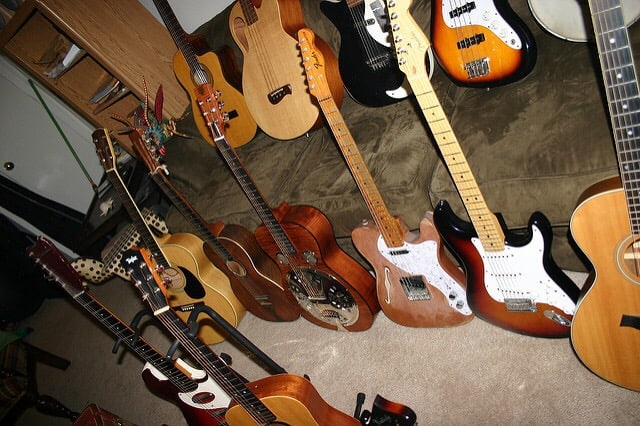 Various guitars on couch and carpeted floor, a glorious sight to see. Photo courtesy of Pedula Man from flickr.com