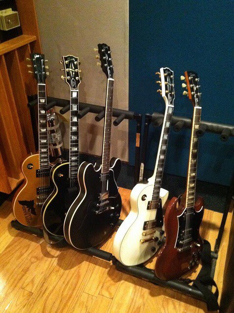 Different guitars in rack.