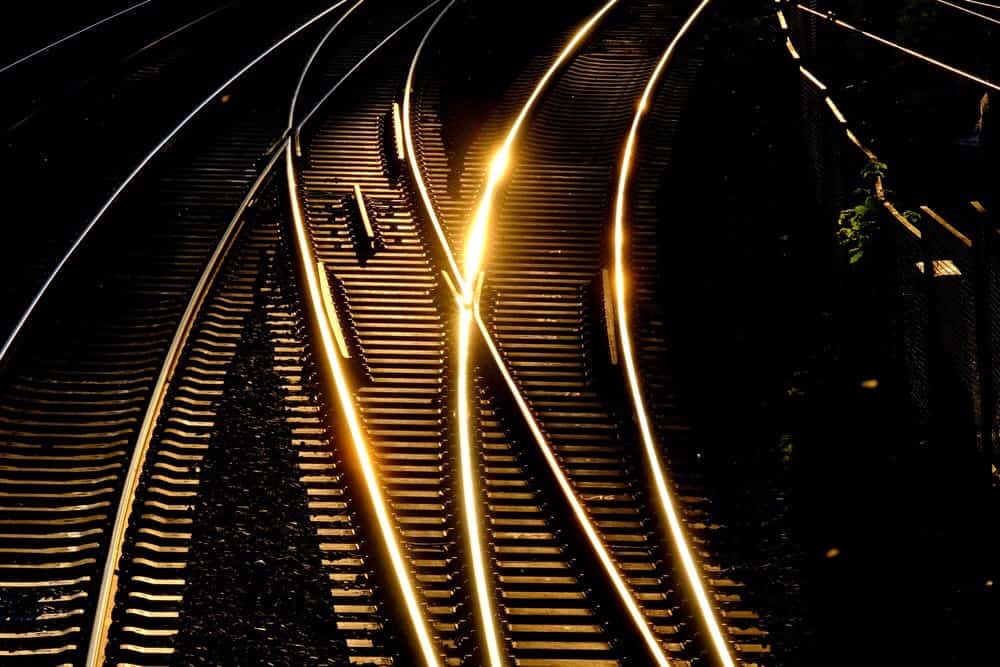 Three railroad tracks, with change off, for different direction for trains.