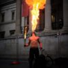 Featured image: Man breathing MASSIVE fire outside his mouth, entertaining people.