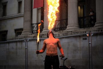 Featured image: Man breathing MASSIVE fire outside his mouth, entertaining people.