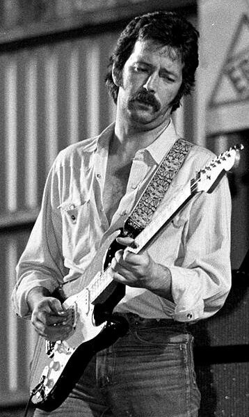 Eric Clapton of very famous fame playing guitar. Black and white picture.