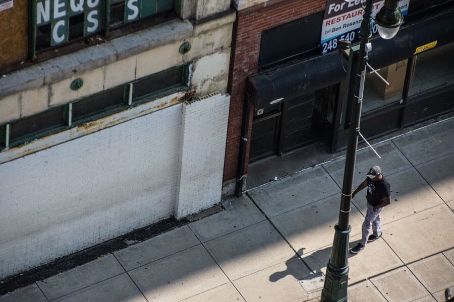 Bird view of buildings and man walking.