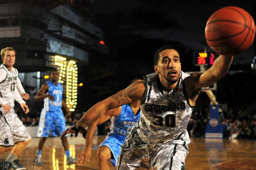 Pro Basketball player reaching for ball.