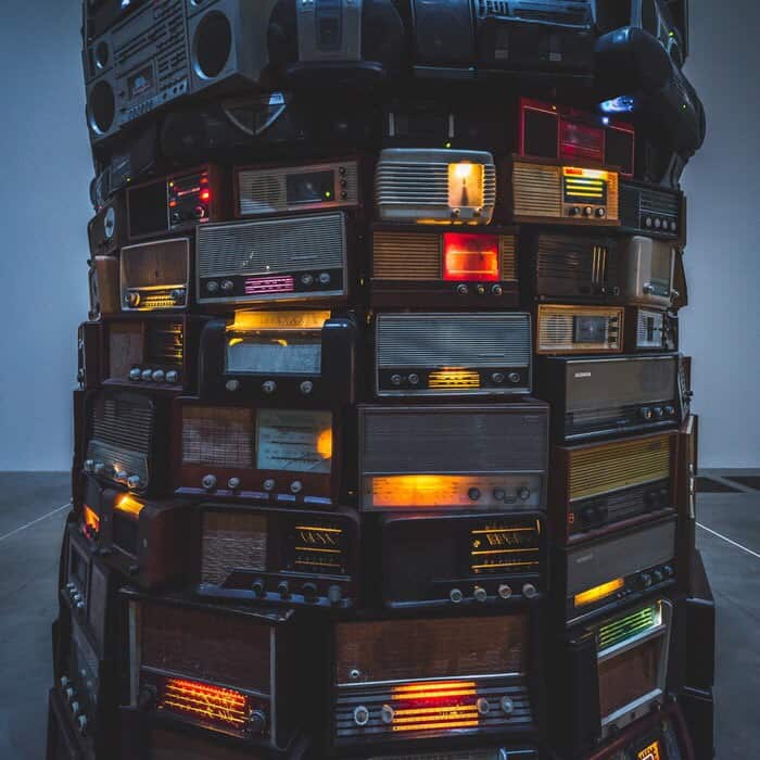 Lots and lots of radios, stacked up on top of each other, side by side, in rows.