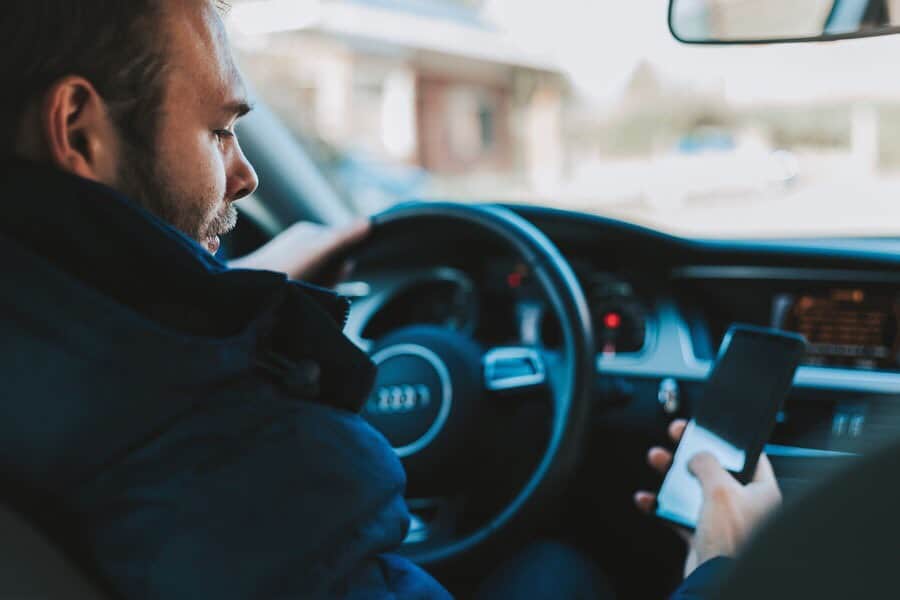 Man inside of car listening to cellphone. Inside of car point of view.