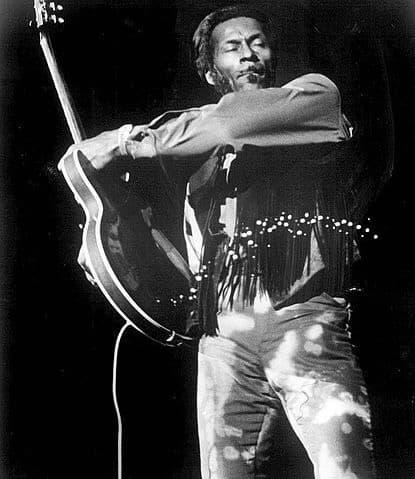 Chuck Berry with attitude. Swinging and playing guitar. Black and white picture. © Early 1970s. Author: 1950s Rock & Roll Revival.