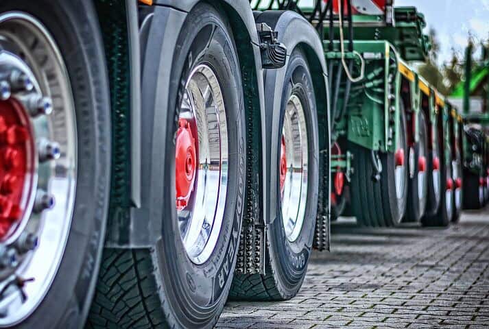 Giant huge wheels on truck on the road.