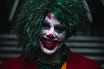 The JOKER smiling with a joker type smile.