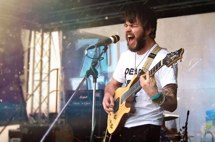 Musician rocking out with his guitar.