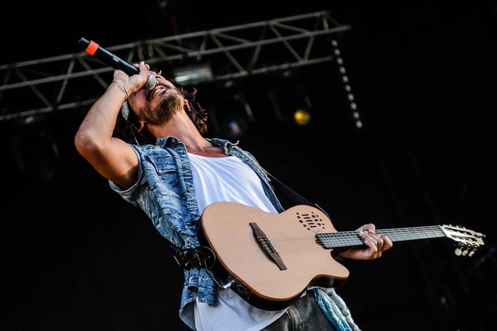 Musician singing into a microphone.