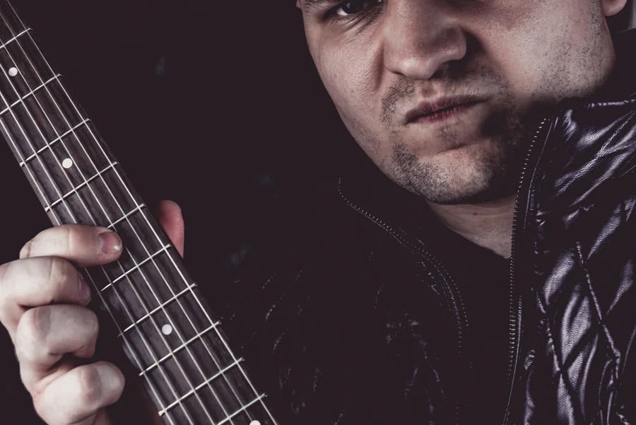 Musician playing a note on the guitar.